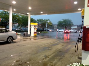 Standing at the gas station waiting for rain to stop